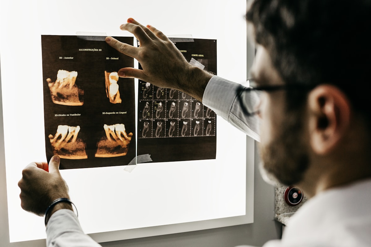 Dentist treating a patient at a dental college hospital using a dental college hospital management system